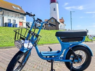 electric green bike bicycle on a beautiful bright day Netherlands Urk, blue electric fatbike